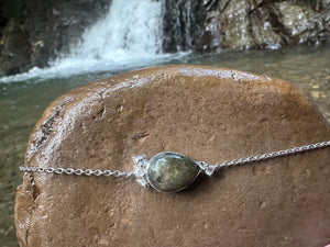 1. Unbroken sterling silver labradorite bracelet displayed outdoors
